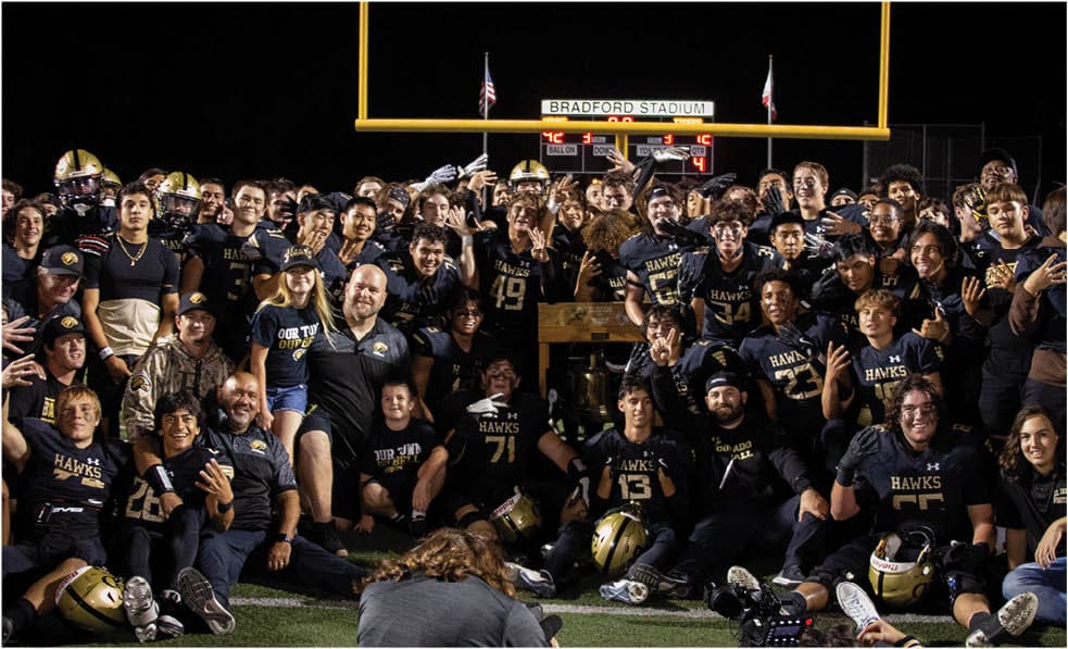 A group of football players celebrating a touchdown. Description generated by AI