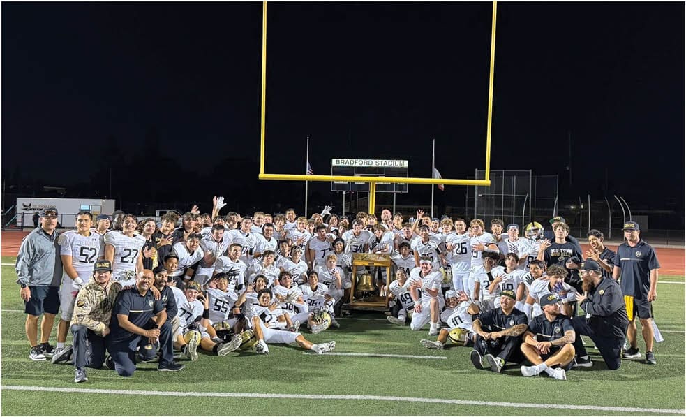 A group of football players celebrating a touchdown. Description generated by AI