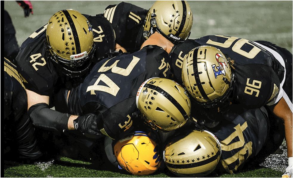 A group of football players celebrating a touchdown. Description generated by AI