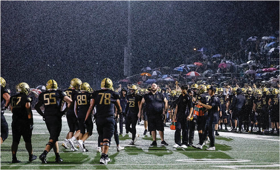 A group of football players celebrating a touchdown. Description generated by AI