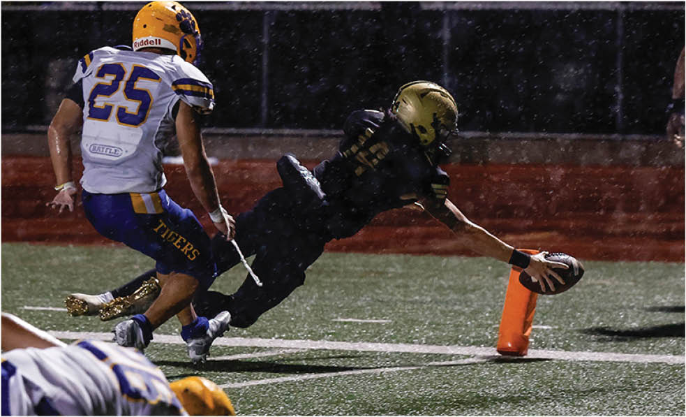 A group of football players celebrating a touchdown. Description generated by AI