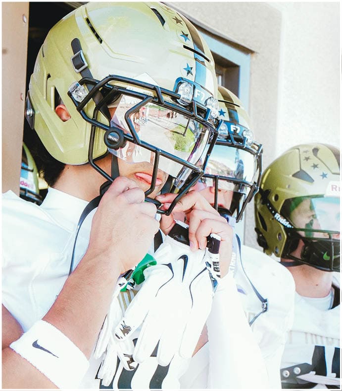 A group of football players on a field. Description generated by AI