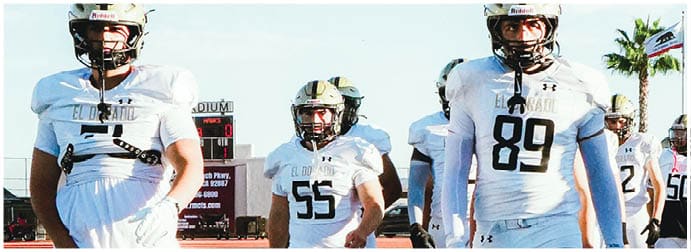 A group of football players on a field. Description generated by AI
