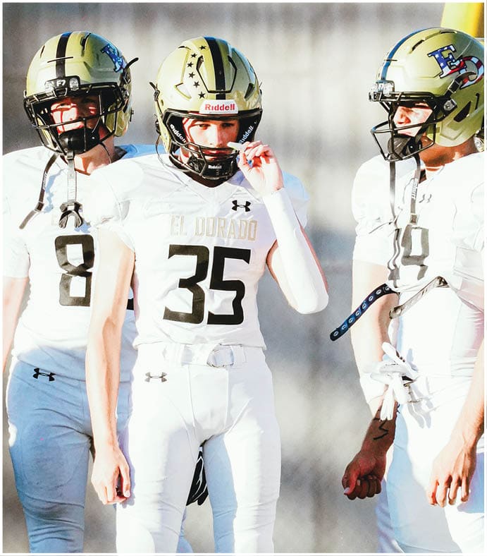A group of football players on a field. Description generated by AI