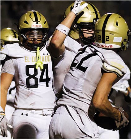 A group of football players celebrating a touchdown. Description generated by AI