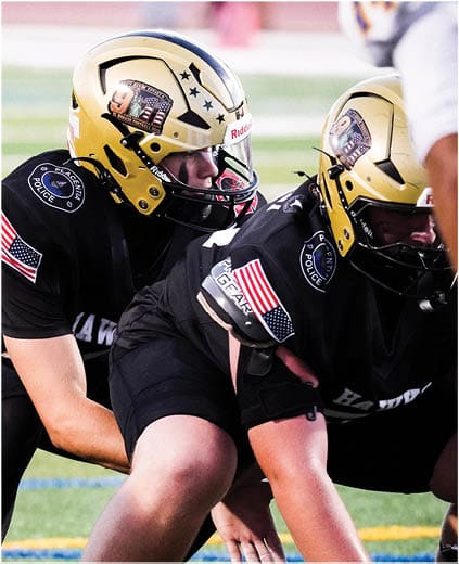 A group of football players on a field. Description generated by AI
