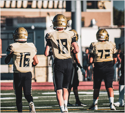 A group of football players on a field. Description generated by AI