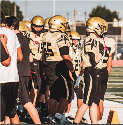 A group of football players celebrating a touchdown. Description generated by AI