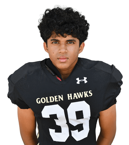A person with curly hair wearing a black football jersey with the number 39 and the words “Golden Hawks" stands facing forward. Description generated by AI
