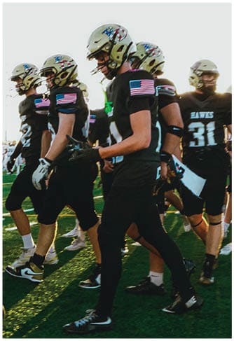 A group of football players celebrating a touchdown. Description generated by AI