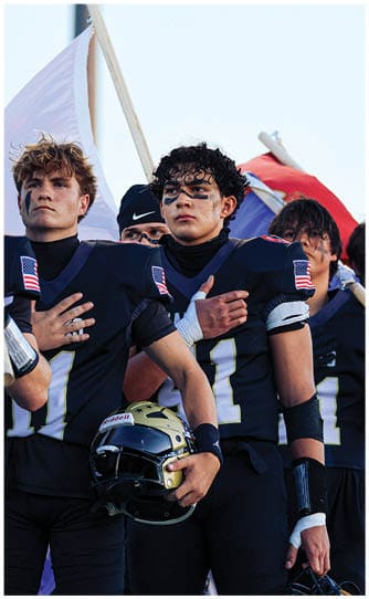 A group of football players on a field. Description generated by AI