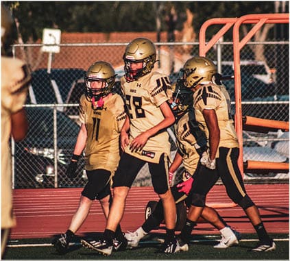 A group of football players on a field. Description generated by AI