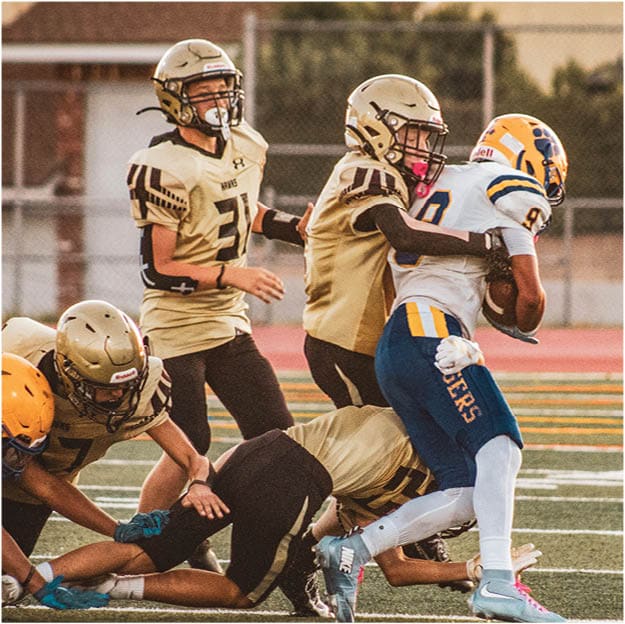 A group of football players celebrating a touchdown. Description generated by AI