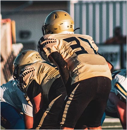 A group of football players celebrating a touchdown. Description generated by AI