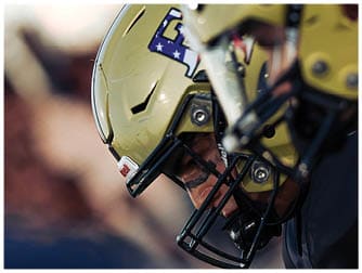 A group of football players on a field. Description generated by AI