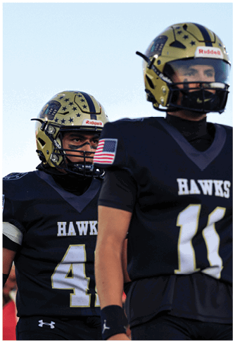 A group of football players celebrating a touchdown. Description generated by AI