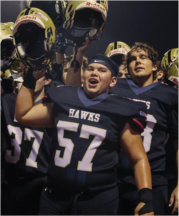 A group of football players on a field. Description generated by AI