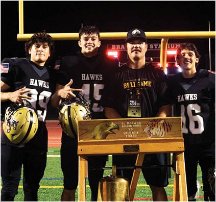 A group of football players on a field. Description generated by AI