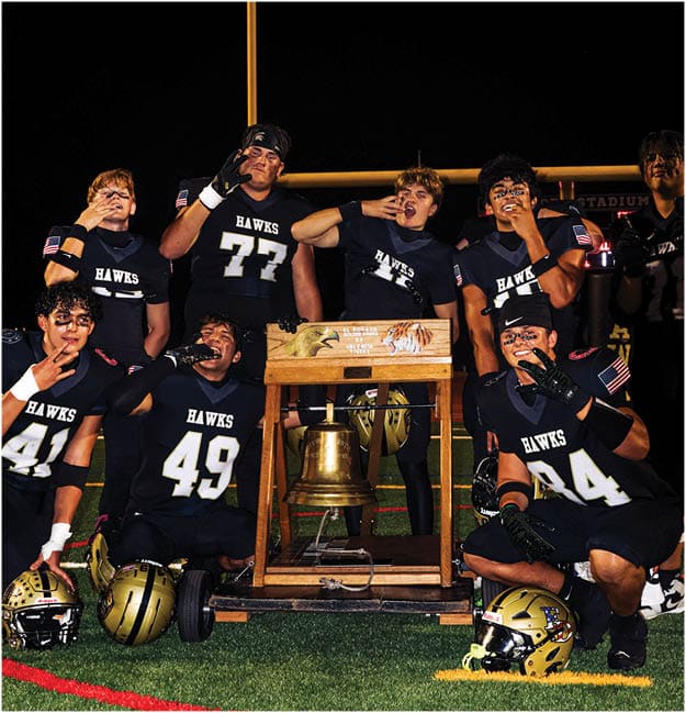 A group of football players celebrating a touchdown. Description generated by AI