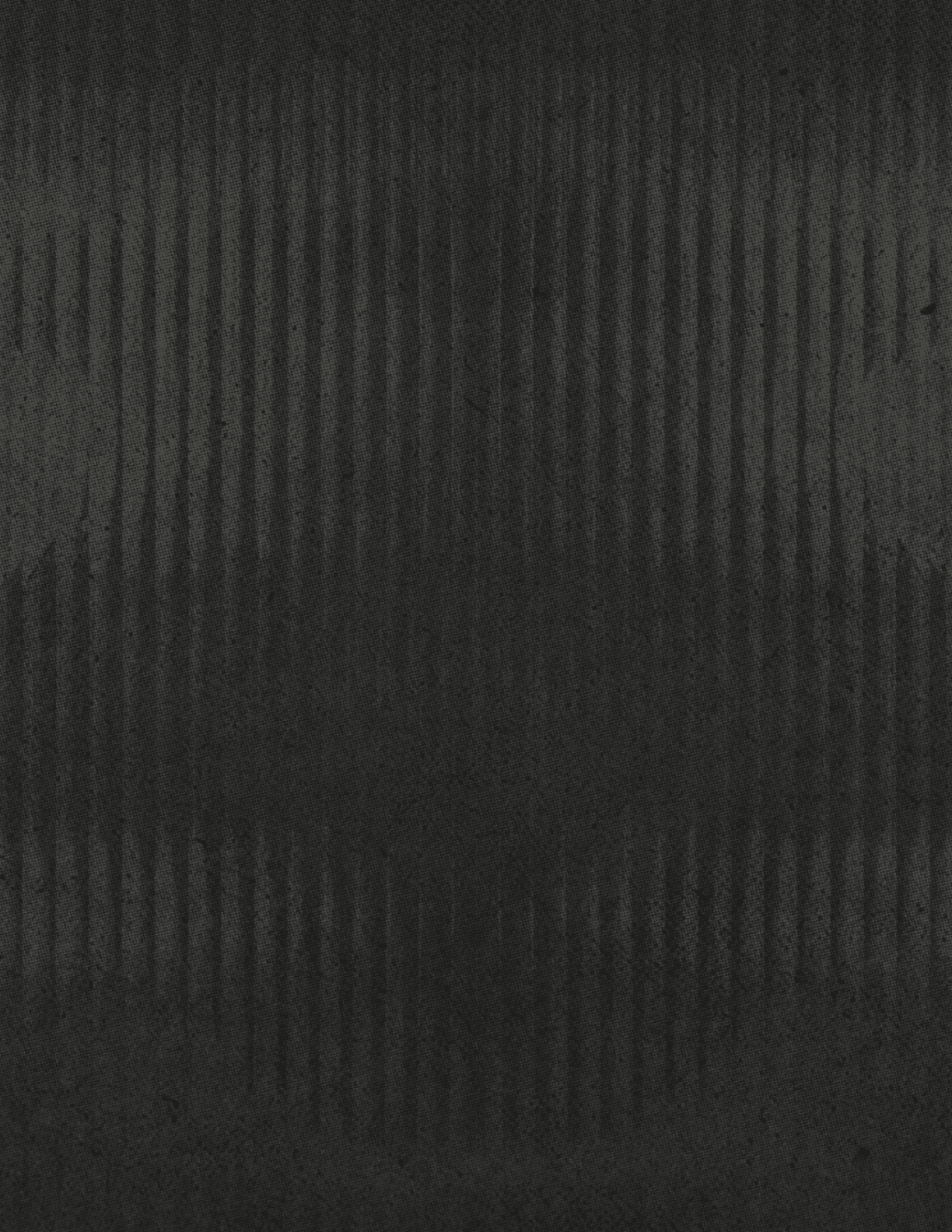 A dark textured surface with vertical ridges creating a subtle pattern across the entire image. Description generated by AI