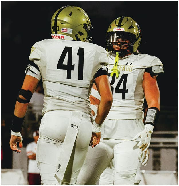 A group of football players celebrating a touchdown. Description generated by AI