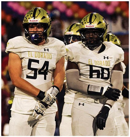 A group of football players celebrating a touchdown. Description generated by AI