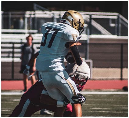 A group of football players on a field. Description generated by AI