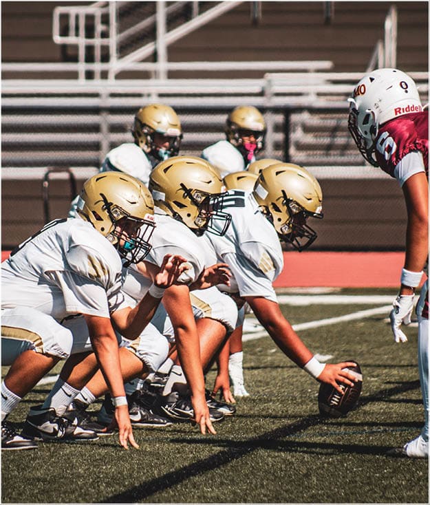 A group of football players on a field. Description generated by AI