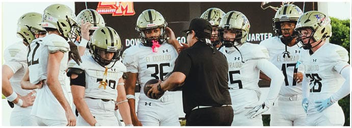 A group of football players on a field. Description generated by AI