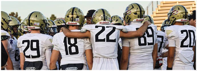 A group of football players on a field. Description generated by AI