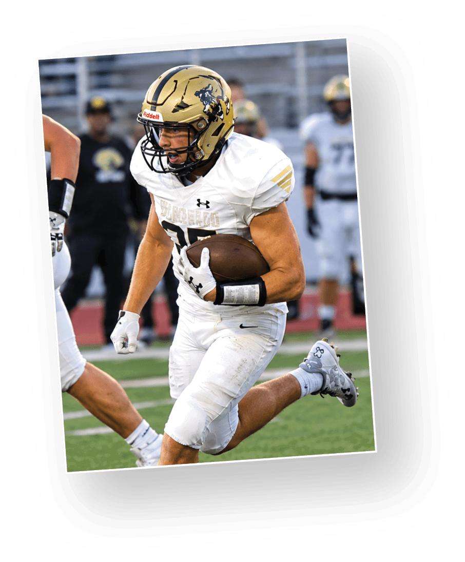 An adult wearing a white football uniform and gold helmet is running on a field while holding a football. Description generated by AI