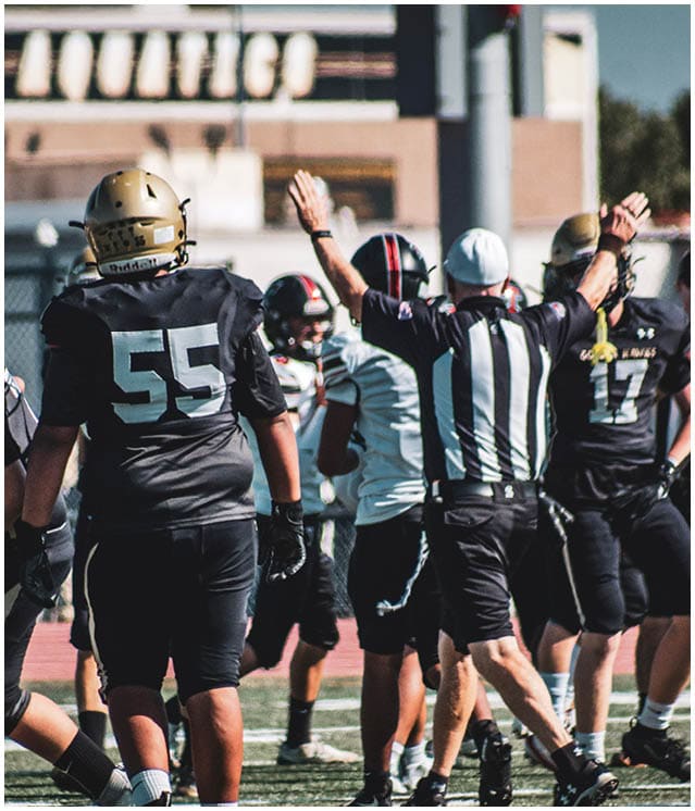 A group of football players on a field. Description generated by AI