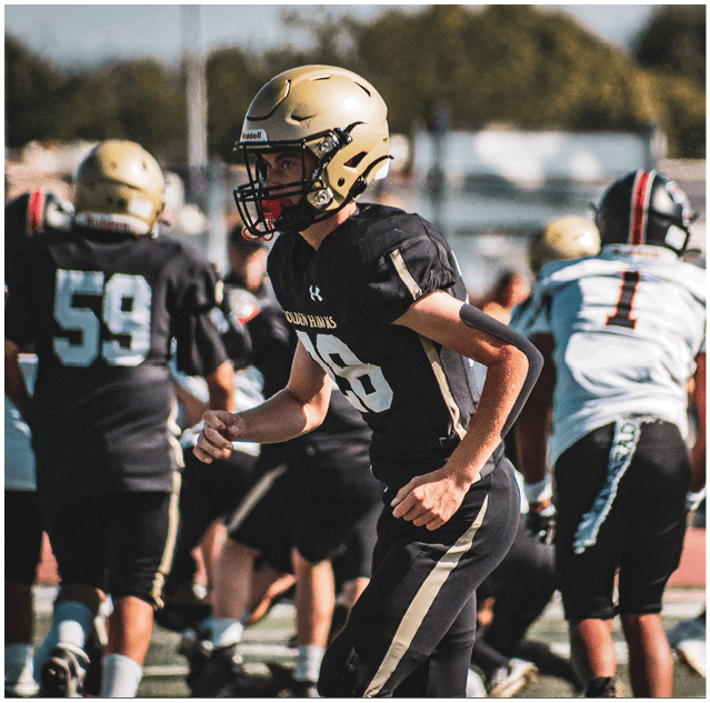 A group of football players celebrating a touchdown. Description generated by AI