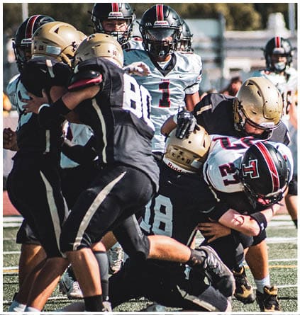 A group of football players celebrating a touchdown. Description generated by AI