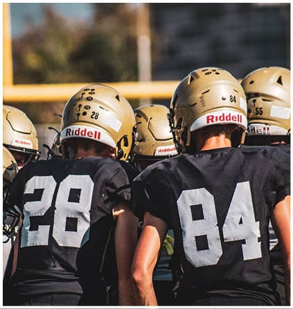 A group of football players celebrating a touchdown. Description generated by AI