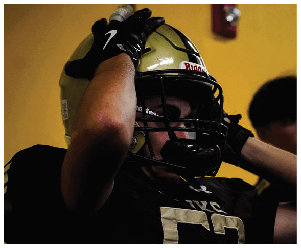 A group of football players wearing black jerseys with the number 3 on them. Description generated by AI