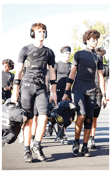 A football player wearing a black jersey with the number 6 on it. Description generated by AI