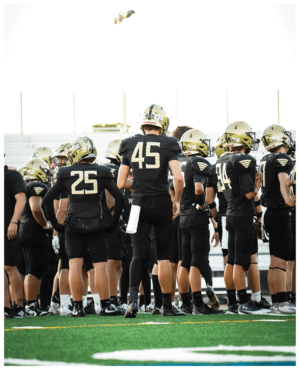 A group of football players wearing black jerseys with the number 3 on them. Description generated by AI