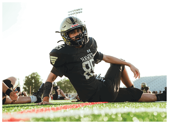 A group of football players wearing black jerseys with the number 3 on them. Description generated by AI