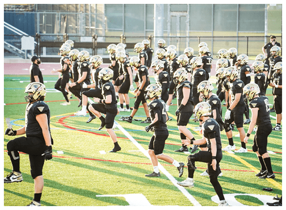 A group of football players wearing black jerseys with the number 3 on them. Description generated by AI