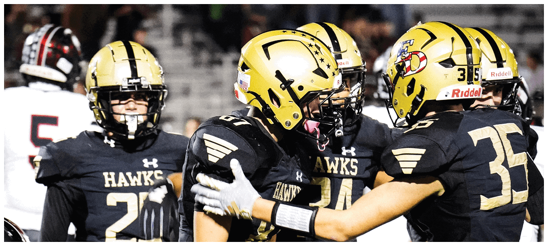 A group of football players on a field. Description generated by AI