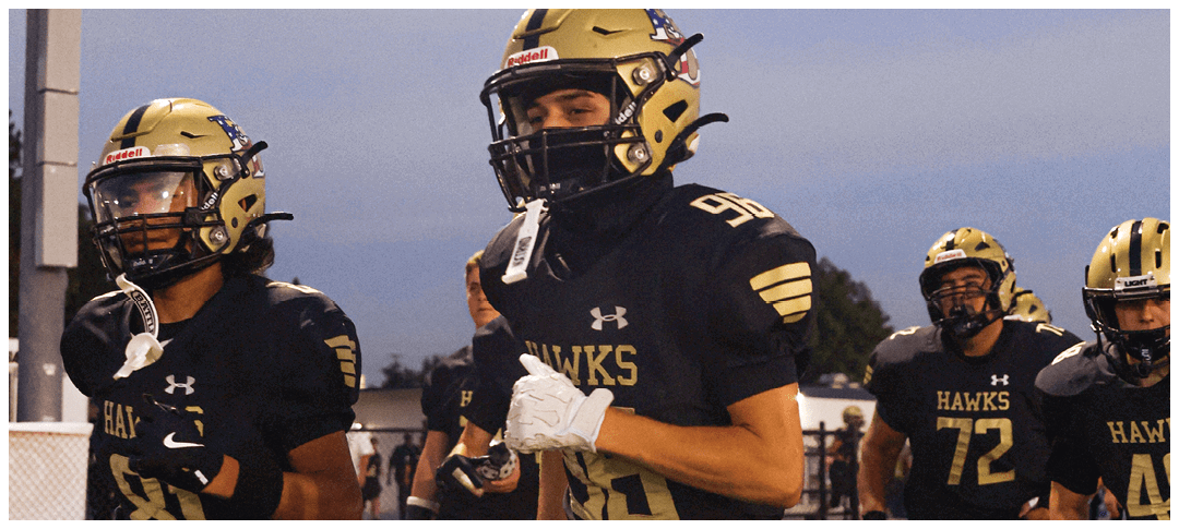 A group of football players on a field. Description generated by AI