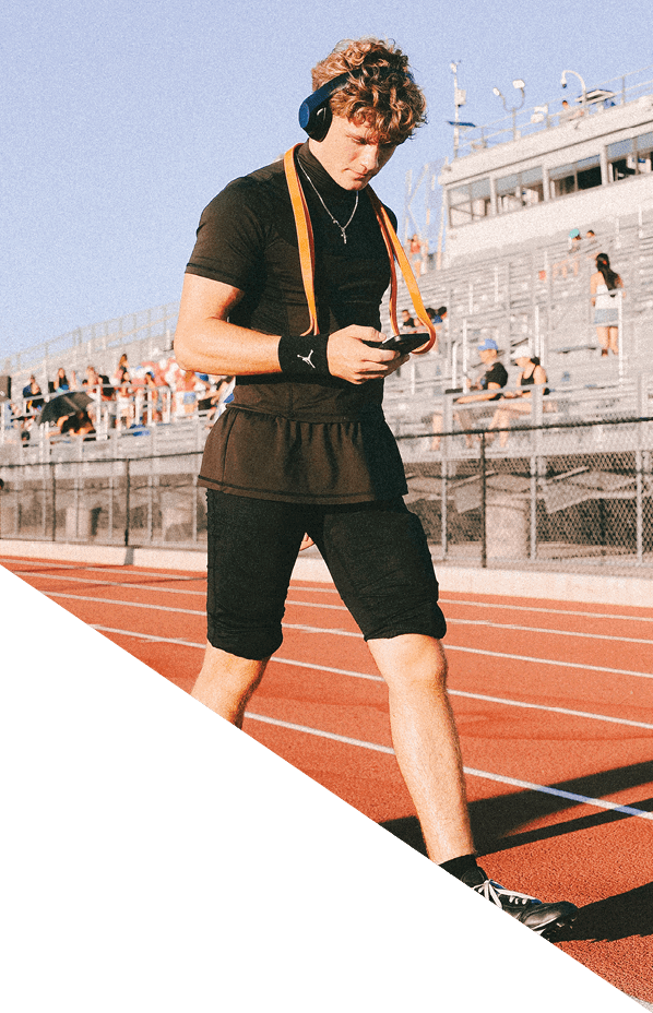 A football player is kneeling on the field, holding his helmet in his hands. AI generated content