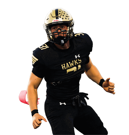 A person wearing a black football uniform and gold helmet is standing on a field in an athletic stance. Description generated by AI