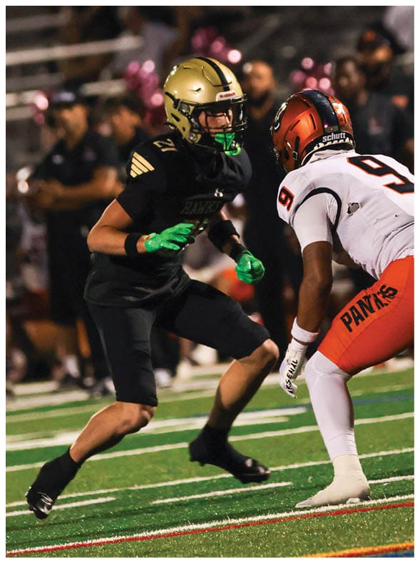 A group of football players wearing black jerseys with the number 3 on them. Description generated by AI