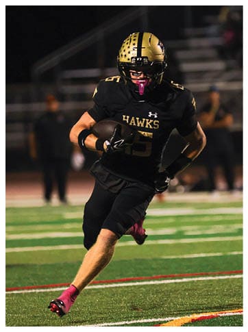A football player running on the field. Description generated by AI