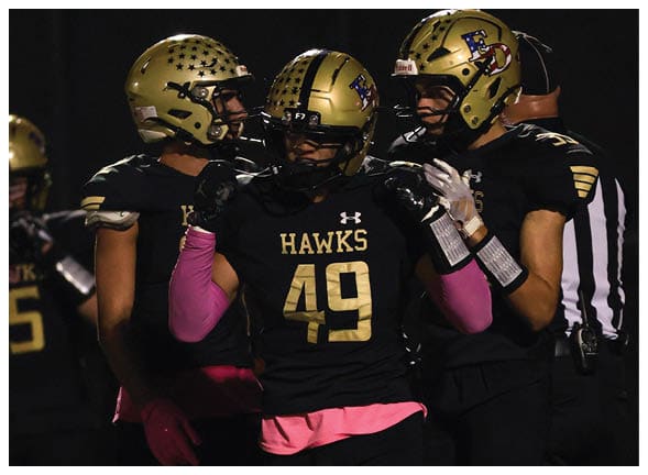 A group of football players wearing black jerseys with the number 3 on them. Description generated by AI