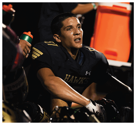 A football player wearing a black jersey with the number 6 on it. Description generated by AI