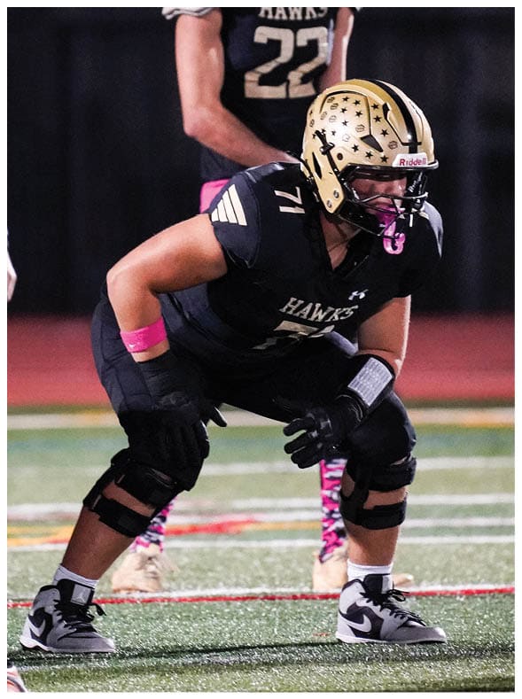 A group of football players wearing black jerseys with the number 3 on them. Description generated by AI