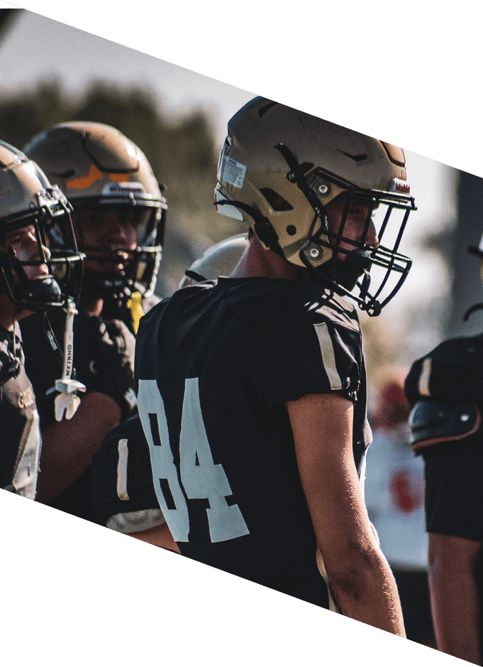 A group of people wearing black jerseys are huddled together on a field. AI generated content